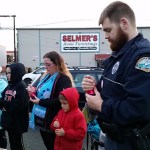 (Terri Harber/The Daily World) Aberdeen Police Officer David Tarrence, pictured in the foreground, is among participants holding candles to commemorate victims and survivors during the 4th Annual Domestic Violence Candle Light Vigil held Wednesday at Zelasco Park. He is a member of the police department&rsquo;s Domestic Abuse Response Team.