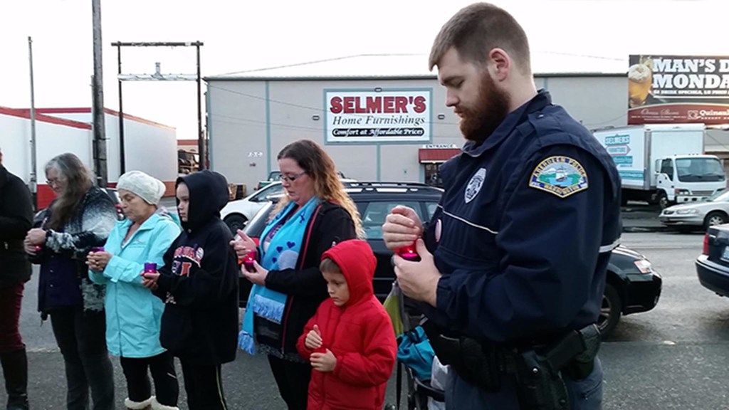 (Terri Harber/The Daily World) Aberdeen Police Officer David Tarrence, pictured in the foreground, is among participants holding candles to commemorate victims and survivors during the 4th Annual Domestic Violence Candle Light Vigil held Wednesday at Zelasco Park. He is a member of the police department&rsquo;s Domestic Abuse Response Team.