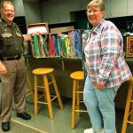 Grays Harbor County Sheriff Rick Scott accepts a donation of 45 children&rsquo;s quilts from Carolyn Douglas, secretary of the Pieceful Discover&rsquo;s Quilt Guild. (Photo submitted by Karen Callahan)