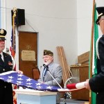 Mike Barkstrom, left, and Bill Sipila, members of Aberdeen&rsquo;s Veterans of Foreign Wars Post 224 Color Guard, conduct a flag-folding ceremony Friday morning during a Veterans Day commemoration event at the local post. (Terri Harber|The Daily World)