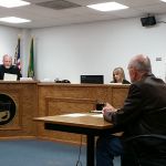 Grays Harbor County Commissioner Frank Gordon, seated in the foreground, appeared Tuesday afternoon in front of Pro-Tem Judge Chris Coker in Aberdeen Municipal Court for arraignment on the misdemeanor charge of removing or defacing political advertising. Gordon is being represented by Aberdeen attorney Jack Micheau, seated to the right of Gordon. (Terri Harber|The Daily World)
