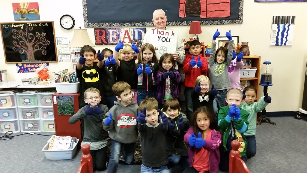 Joe Cornell poses with second graders at McDermoth Elementary School on Wednesday. The kids are modeling gloves Cornell distributed to them and the other nearly 400 children there. (Terri Harber|The Daily World)