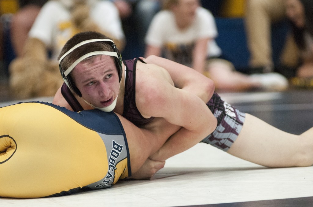 (Brendan Carl | The Daily World) Montesano&rsquo;s Jacob Ellefson tries to pin Aberdeen junior Tyler Souphommanichanh during the 132-pound final on Saturday.