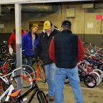 Lions Club volunteers mill among the more than 100 bicycles given away Saturday as part of their Bicycles from Heaven program. Al Waters, in the Lion&rsquo;s Club hat at center, called said of the event, &ldquo;We get to give a bike, the kids get to get a bike, the prisoners get to be part of it, it&rsquo;s a great program.&rdquo; In the red coat behind in the post is Bob Braden. Standing to Waters&rsquo; left with his back to the camera is Dennis Harke. DAN HAMMOCK THE DAILY WORLD