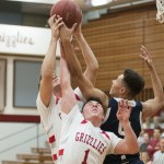 (Brendan Carl | The Daily World) Hoquiam&rsquo;s Jace Varner and Zach Spradlin (1) battle with Cascade Christian&rsquo;s Noah Wilkins for a rebound on Tuesday.