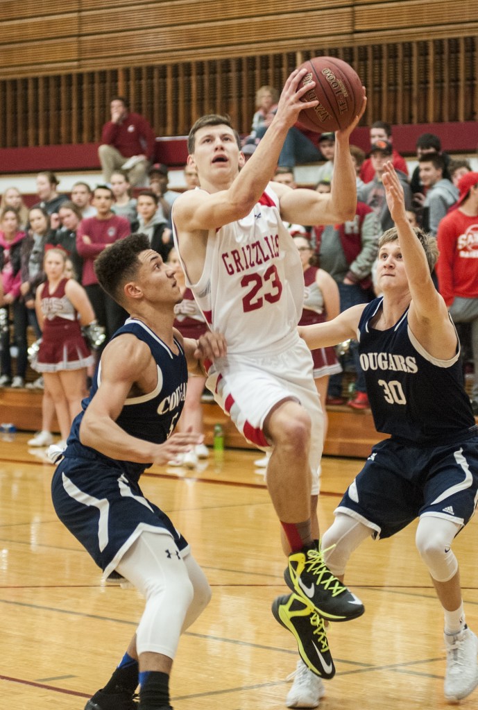(Brendan Carl | The Daily World) Hoquiam&rsquo;s Jack Adams drives between two Cascade Christian defenders on the way to the bucket on Tuesday.