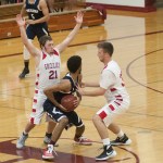 (Brendan Carl | The Daily World) Hoquiam&rsquo;s Jerod Steen (21) and Jace Varner try to trap Cascade Christian&rsquo;s Grayson Jones on Tuesday.