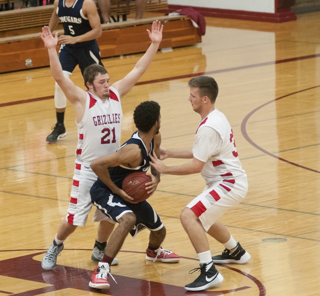 (Brendan Carl | The Daily World) Hoquiam&rsquo;s Jerod Steen (21) and Jace Varner try to trap Cascade Christian&rsquo;s Grayson Jones on Tuesday.