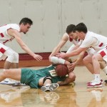 (Brendan Carl | The Daily World) Hoquiam&rsquo;s Anthony Nash, left, Jack Adams III, center, and Zach Spradlin surround a Tumwater player to force a held ball on Friday.