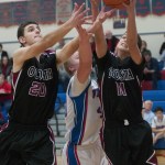 (Brendan Carl | The Daily World) Ocosta&rsquo;s Kaden Smith (20) and Cole Hatton battle with Willapa Valley&rsquo;s Peter Hamilton for a loose ball on Monday.