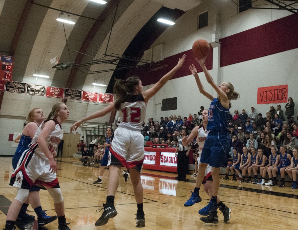 (Brendan Carl | The Daily World) Willapa Valley&rsquo;s Hannah Cook puts up a shot over the outstretched arm of Raymond&rsquo;s Mikayla Collins on Thursday.