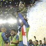 Dan Poss | Sounders FC Seattle Sounders FC Defender Román Torres hoists the MLS Cup trophy.