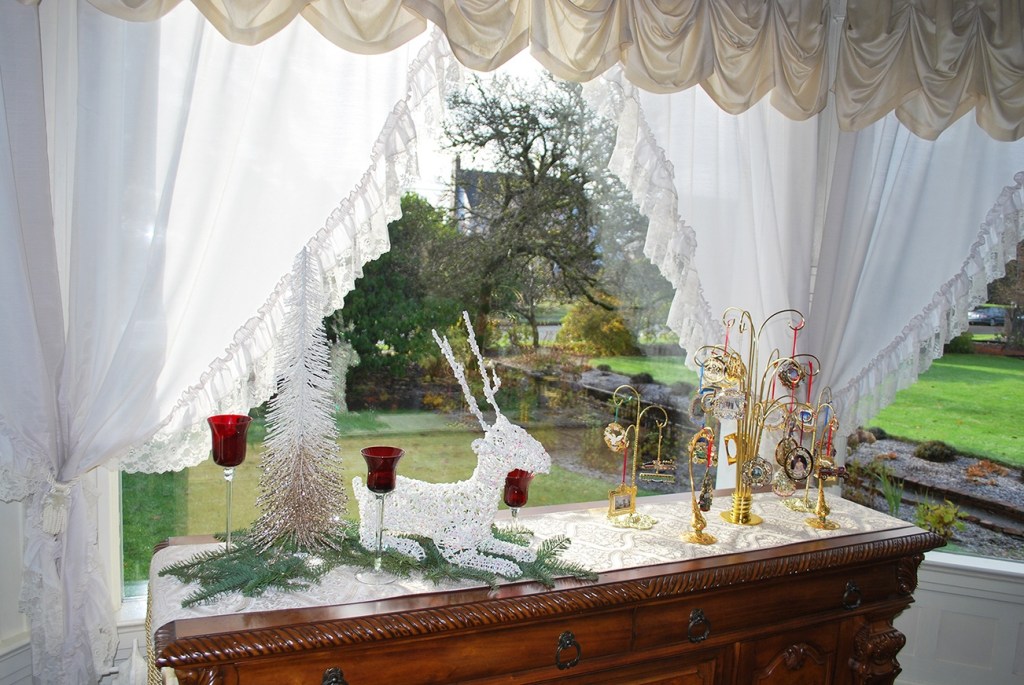A seasonal display is framed by a window inside the Aberdeen Mansion. Morning light adds more shine to these tasteful holiday objects. (Terri Harber|The Daily World)