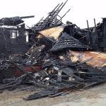 The charred remains viewed from the side of a wood-frame home at 411 South Michigan St. after a fire early Sunday. The roof of the business across the alley, Harbor Battery, was also burned. (Terri Harber|The Daily World)