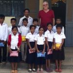 Ed Schroll photograph                                Ed Schroll joins a group of the students he is able to help in Cambodia for his non-profit Caring for Poor and Orphaned Children Foundation.