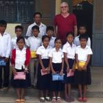 Ed Schroll photograph                                Ed Schroll joins a group of the students he is able to help in Cambodia for his non-profit Caring for Poor and Orphaned Children Foundation.