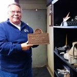 Bill Newman shows one of the many nameplates cast by the Bergstrom Foundry. The co-owner has retired after more than 20 years there leading sales and marketing efforts. (Terri Harber|The Daily World)