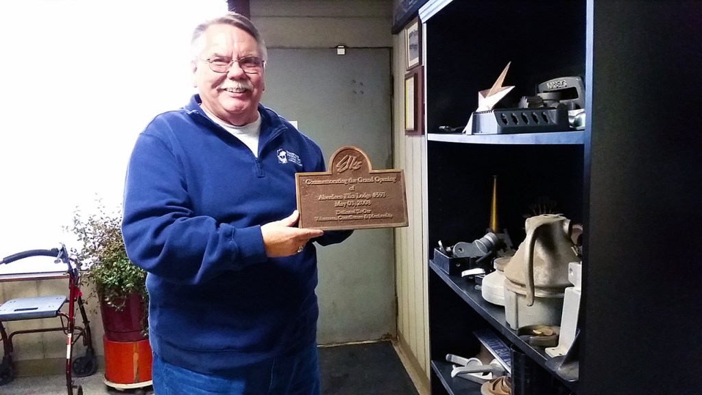 Bill Newman shows one of the many nameplates cast by the Bergstrom Foundry. The co-owner has retired after more than 20 years there leading sales and marketing efforts.(Terri Harber|The Daily World)
