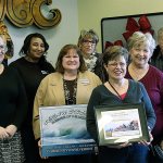 (NORTH COAST NEWS) New Ocean Shores/North Beach Chamber Director Piper Leslie, far left, joins the Ocean Shore/North Beach Chamber Ambassadors in presenting the Business of the Month award to Marlene Thomasson and the Ocean Shores Observer.
