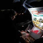 Sonia Garcia sells Krispy Kreme doughnuts, purchased across the border in El Paso, Texas from the trunk of her car on a busy street in Ciudad Juarez, Mexico. The money she and her family make selling doughnuts helps pay for her son to go to college. (Katie Falkenberg/Los Angeles Times)