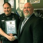 Sgt. Shane Krohn with the Hoquiam Police Department receives a letter of appreciation from Anthony Galetti, Inspector in Charge, Seattle Division, U.S. Postal Service. (HOQUIAM POLICE DEPARTMENT PHOTO)