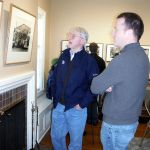 Polson Museum Director John Larson (right) celebrated 20 years at the helm at a reception Sunday at the museum. Here he checks out the museum&rsquo;s yet-to-open John Tylczak exhibition of photos featuring local loggers in the 1980s with former Daily World editor and current chief historian for the state&rsquo;s oral history program.