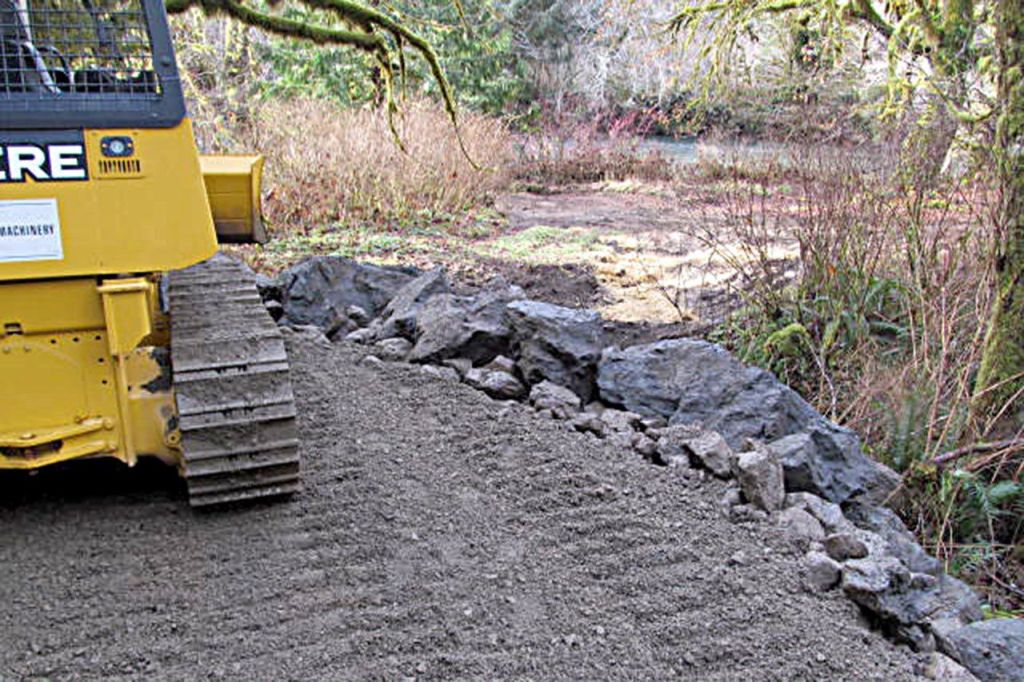 What once was a popular vehicle access point to a gravel bar on the West Fork Humptulips River was blocked with boulders at its confluence with Forest Service Road 2203 Monday. Beyond the boulders is the old access road, which leads about 200 feet to the river.