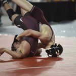 (Sue Michalak) Montesano&rsquo;s Jacob Ellefson tries to pin Wahluke&rsquo;s Felix Rangel in the first round of the Mat Classic at the Tacoma Dome on Friday. Ellefson won the match 17-3 and will wrestle in the 120-pound semifinals today.