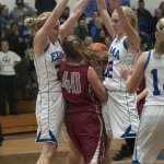 (Brendan Carl | The Daily World) Elma&rsquo;s Molly Johnston, left, and Brooke Sutherby collapse on Hoquiam&rsquo;s Kylee Bagwell during an Evergreen 1A League contest earlier this season.