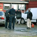 A member of the Washington State Patrol Bomb Squad Unit removes a suspicious device from the home on Wheeler Avenue in Hoquiam. (BOB KIRKPATRICK|THE DAILY WORLD)