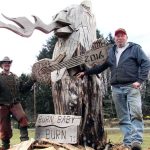 Burning Bear co-founder Ivan Hass, right, and carver James Haskett, of Butte, MT, look forward to lighting up the massive wooden sculpture Saturday around dusk at the event held at Ocean City Marketplace on SR 109.