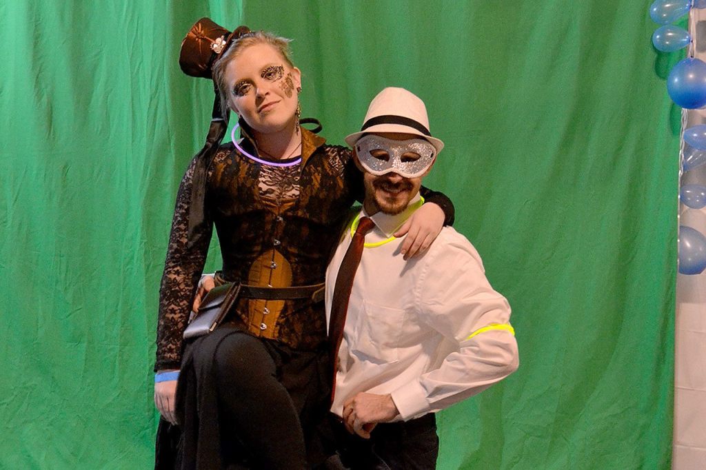 Taylor Barcomb and Jeff Boyle pose in front of a green screen. (STEVEN PUVOGEL EVENTS ON EMERSON)