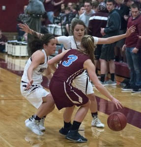 (Brendan Carl | The Daily World) Montesano&rsquo;s Hannah Quinn, left, and Josie Toyra trap Stevenson&rsquo;s Kaitlyn Rathgeber during a District IV 1A tournament game at Bo Griffith Gym on Friday. Monte defeated Stevenson 69-26.