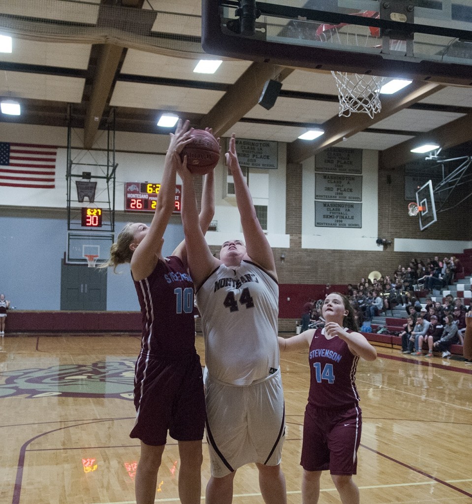 (Brendan Carl | The Daily World) Montesano&rsquo;s Jordan Spradlin stretches to battle for a rebound with Stevenson&rsquo;s Laura Hobbs on Friday.