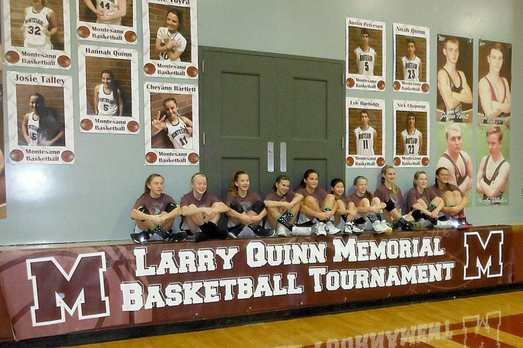 The fourth annual Larry Quinn Memorial Basketball Tournament was held at the Bo Griffith Memorial Gymnasium in Montesano over the weekend, attracting 150 girls from across the region and raising thousands of dollars for scholarships. Quinn, longtime Montesano High School girls basketball coach, passed away suddenly in 2013. Pictured in the background on the left are senior portraits of graduating Montesano girls basketball players, who were the last class Quinn coached.