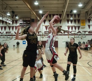 (Brendan Carl | The Daily World) Raymond&rsquo;s Winter Newman goes up for a shot as Ilwaco&rsquo;s Madelin Jacobson tries to get a block during a regional 2B girls contest at Chehalis on Saturday. The Fisherman defeated the Seagulls 57-36.