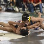 (Sue Michalak) Aberdeen&rsquo;s Tyler Souphommanichanh pins Noah Arelolo of Renton in the first round of the Mat Classic on Friday.