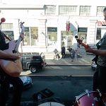 First Fridays are a staple of the burgeoning Aberdeen music scene, known as The Alley. That&rsquo;s when a dozen or more local businesses, ranging from bars to jewelry stores, invite local artists to share their music. The relationship is a symbiotic one, giving artists a chance to showcase their music and giving people a reason to travel to downtown Aberdeen to enjoy it. The driving force behind The Alley, Wil Russoul, kicks off a recent First Friday with an impromptu set atop the marquee at the D&R Theatre. With him is Michael B. Johnson, who studied music and Grays Harbor College and is continuing his music education at The Evergreen State College. Not pictured is drummer Evan Mehlhoff, who plays with the Aberdeen based band Vinyl Moon. In the background are Boomtown Records and Wiitamaki&rsquo;s Jewelers, both businesses who provide local musicians with places to play.