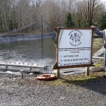 Doug Warnken stands next to one of the holding ponds at the Mayr Brothers Hatchery in Aberdeen. He and other Poggie Club members have devoted many hours to helping the hatchery operate. (Terri Harber|The Daily World)