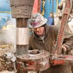 A deckhand on a Sandridge Energy oil rig change out a drill pipe in a fracking operation on the Oklahoma border in Harper County, Kan., in February 2012. A 3.8-magnitude quake in the area on December 16, 2013, rattled windows, cracked walls and shook furniture. (Bo Rader/Wichita Eagle)
