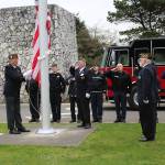 Angelo Bruscas | GFH Newspaper Group                                VFW Post 8956 members Dennis Hogan, Dan Martin, John Link and Jim Docherty present the flag with Ocean Shores firefighters in the background.