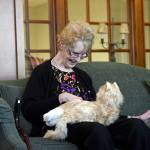 Anne Dongarra, a resident of Glen Meadows Retirement Community in Glen Arm, Maryland, pets &ldquo;Henry,&rdquo; a robotic companion cat that responds to petting and motion. (Kim Hairston/Baltimore Sun)