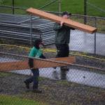 Ron Montoure of Hoquiam Youth Baseball and Dominic Standstipher help carry lumber for a project.