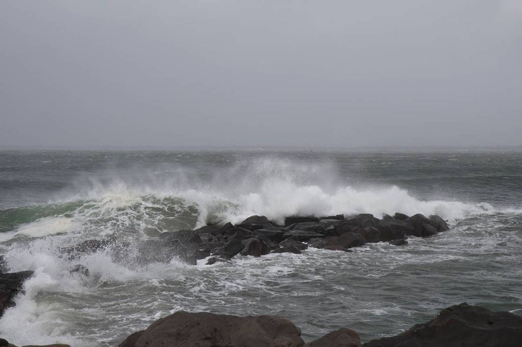 Waves, whipped by high winds, crash over the rocks at Westport on Friday afternoon.                                (Travis Rains | GH Newspaper Group)