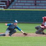 (Brendan Carl | The Daily World) Elma&rsquo;s Colten French waits to tag Hoquiam&rsquo;s Jackson Folkers out at second base. Elma defeated Hoquiam 3-0 in the first game on Thursday before the Grizzlies won the nightcap 17-1.