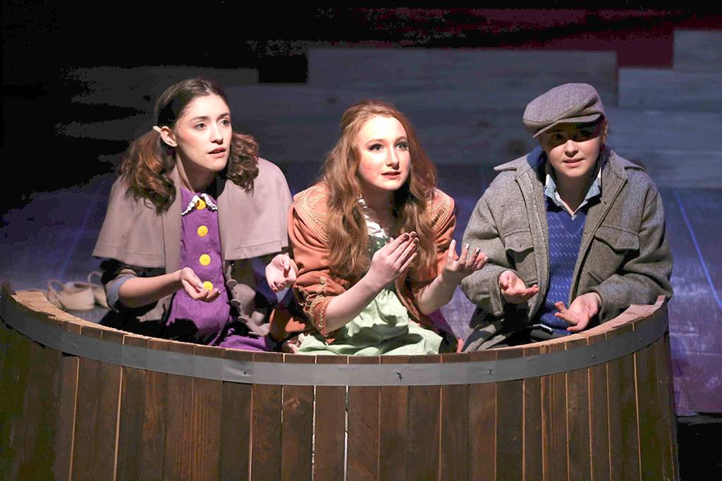 Above: Grotto Good (Casey Bronson, left) and and Gretta Good (Julayne Fleury, right) tell Iris (Chaela Watkins) about her new life in their castle. Below: From left, Iris (Chaela Watkins), Hazel (Emma Dorsch) and Elmer (Amelia Moore) play in the rain.