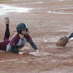 (Brendan Carl | The Daily World) Montesano&rsquo;s Cheyann Bartlett slides into third base ahead of the tag from Elma&rsquo;s Kali Rambo during an Evergreen 1A League game on Friday.