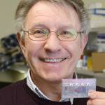 Dr. Lawrence Vernetti, research associate professor at the University of Pittsburgh&rsquo;s Drug Discovery Institute, holds a one-chamber microfluidic device at the BioMedical Science Tower. (Nate Guidry/Pittsburgh Post-Gazette)