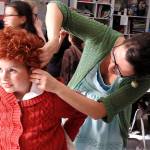 North River teacher Heather Johnson, who directs the school&rsquo;s annual elementary plays, helps fifth-grader Sierra Fuquay (playing Annie) with her microphone. (Photo by Kat Bryant | The Daily World)