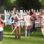 Heather Johnson leads the young cast members in calisthenics to loosen them up before curtain time. (Photo by Kat Bryant | The Daily World)